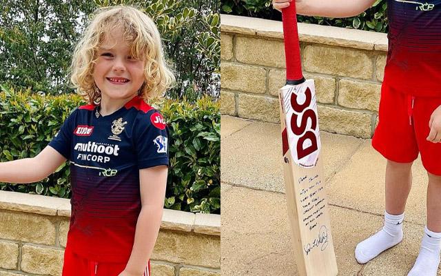 David Willey's son poses with bat gifted by Virat Kohli.