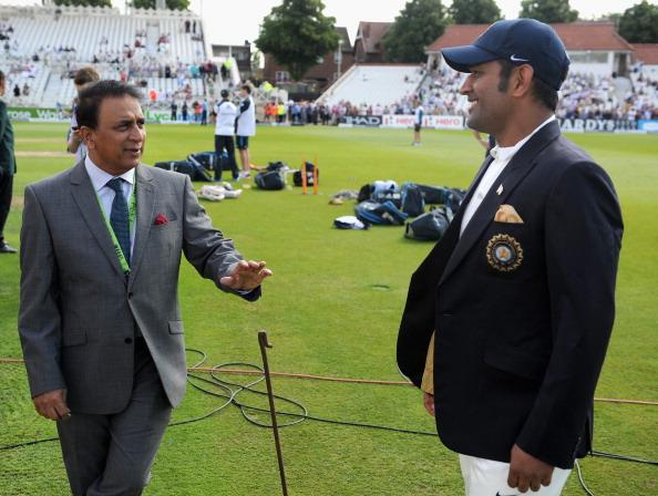 Former Indian cricketer Sunil Gavaskar speaks with Mahendra Singh Dhoni