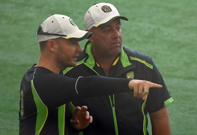 Australian captain Michael Clarke (L) speaks with coach Darren Lehmann during an indoor training session ahead of their 2015 Cricket World Cup match against Bangladesh at the Bupa National Cricket Centre in Brisbane on February 20, 2015.   (Photo by INDRANIL MUKHERJEE/AFP/Getty Images)