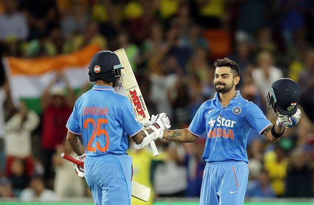 CANBERRA, AUSTRALIA - JANUARY 20: Virat Kohli of India celebrates with team mate Shikhar Dhawan after scoring a century during the Victoria Bitter One Day International match between Australia and India at Manuka Oval on January 20, 2016 in Canberra, Australia. (Photo by Mark Metcalfe - CA/Cricket Australia/Getty Images)