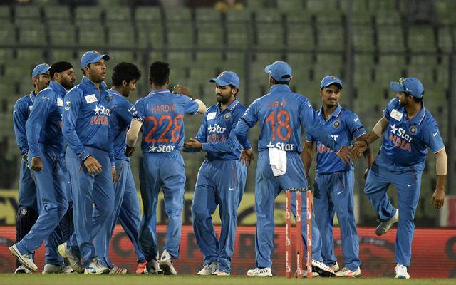 Indian cricketers celebrate after the dismissal of Mohammad Shahzad