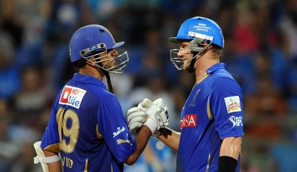 RESTRICTED TO EDITORIAL USE. MOBILE USE WITHIN NEWS PACKAGE Rajasthan Royals' batsman Rahul Dravid (L) congratulates his teammate Shane Watson after a shot during the IPL Twenty20 match between Rajasthan Royals and Mumbai Indians at The Wankhede Stadium in Mumbai on May 20, 2011. Rajasthan Royals won the match by 10 wickets. AFP PHOTO/Indranil MUKHERJEE (Photo credit should read INDRANIL MUKHERJEE/AFP/Getty Images)