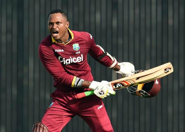 West Indies batsman Marlon Samuels celebrates after scoring his century (100 runs) during the 8th One Day International match of the Tri-nation Series between Australia and West Indies at the Kensington Oval stadium in Bridgetown on June 21, 2016. / AFP / Jewel SAMAD (Photo credit should read JEWEL SAMAD/AFP/Getty Images)