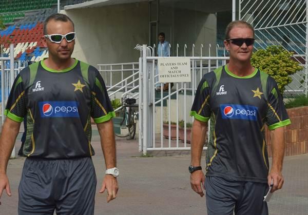 Pakistani cricket team batting coach Grant Flower (R) arrives with fielding coach Grant Luden for a news conference in Lahore on July 18, 2014. Grant Flower stressed improving Pakistan's faltering batsmen will be a "challenge" as he assumed the new role after helping his native Zimbabwe in the recent past. AFP PHOTO/Arif ALI (Photo credit should read Arif Ali/AFP/Getty Images)