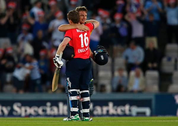 England's Captain Eoin Morgan (L) and England's Jos Buttler embrace after England win the game. (Photo by IAN KINGTON/AFP/Getty Images)