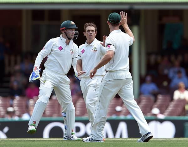 Australian spinner Stephen O'Keefe (C) is congratulated by teammates Mitch Marsh (R) and Peter Nevill (L) after dismissing West Indies batsman Denesh Ramdin on the final day of the third cricket Test match in Sydney on January 7, 2016. AFP PHOTO / William WEST --IMAGE RESTRICTED TO EDITORIAL USE - NO COMMERCIAL USE-- / AFP / WILLIAM WEST (Photo credit should read WILLIAM WEST/AFP/Getty Images)