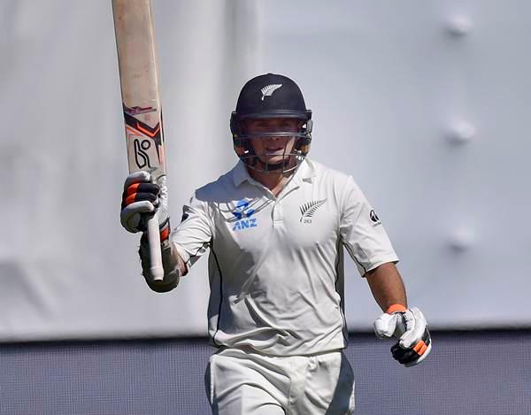 New Zealand's Tom Latham celebrates 50 runs during day three of the first cricket Test match between New Zealand and Australia at the Basin Reserve in Wellington on February 14, 2016. AFP PHOTO / MARTY MELVILLE / AFP / Marty Melville (Photo credit should read MARTY MELVILLE/AFP/Getty Images)