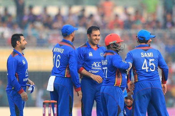 Afghanistan cricketers congratulate Mohammad Nabi (3L) after the dismissal of Bangladesh cricketer Shakib Al Hasan during the second One Day International (ODI) cricket match between Bangladesh and Afghanistan at the Sher-e-Bangla National Cricket Stadium in Dhaka on September 28, 2016. / AFP / - (Photo credit should read -/AFP/Getty Images)