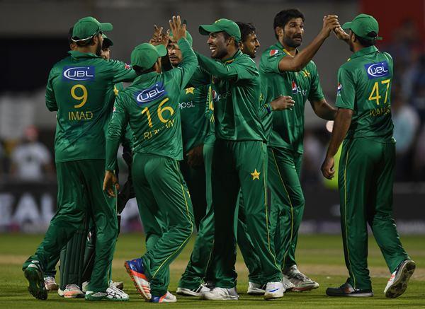 Pakistan's players celebrate at the end of the first innings during the T20 international cricket match between England and Pakistan at The Emirates Old Trafford, in Manchester, north-west England, on September 7, 2016. England finished the innings at 137 for 7. / AFP / PAUL ELLIS / RESTRICTED TO EDITORIAL USE. NO ASSOCIATION WITH DIRECT COMPETITOR OF SPONSOR, PARTNER, OR SUPPLIER OF THE ECB (Photo credit should read PAUL ELLIS/AFP/Getty Images)
