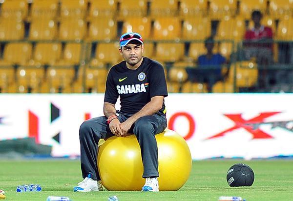 Indian cricketer Virender Sehwag looks on during a practice session at the R. Premadasa Cricket Stadium in Colombo on July 27, 2012. The third one-day international between Sri Lanka and India will be played in Colombo on July 28. AFP PHOTO/ LAKRUWAN WANNIARACHCHI (Photo credit should read LAKRUWAN WANNIARACHCHI/AFP/GettyImages)