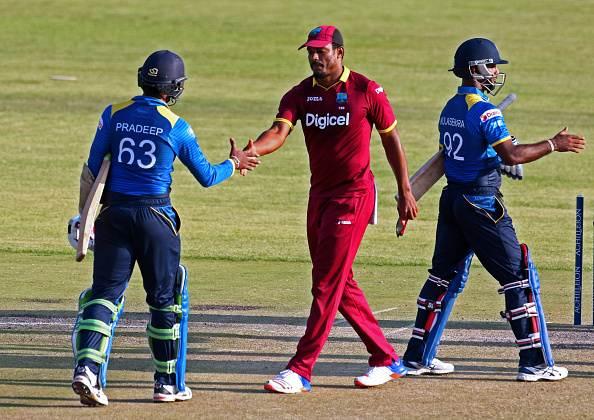 West Indies player Shannon Gabriel (C) shakes hands with Sri Lanka batsman Nuwan Pradeep. (Photo by JEKESAI NJIKIZANA/AFP/Getty Images)