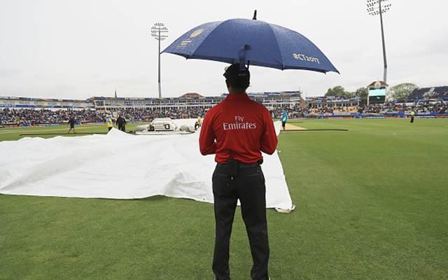 Umpire Kumar Dharmasena looks on, as rain stops play during the ICC Champions Trophy