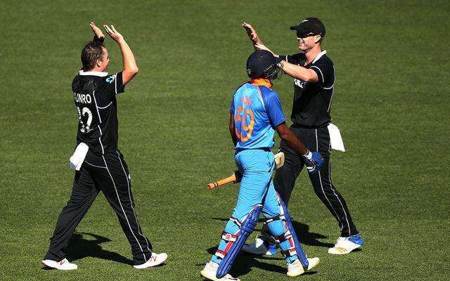 Jimmy Neesham and Colin Munro celebrate after taking the wicket of Vijay Shankar