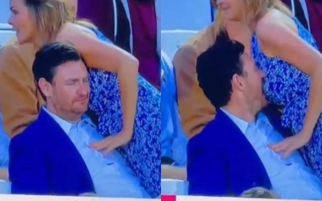 A Man Behaving Inappropriately With A Woman in a stadium