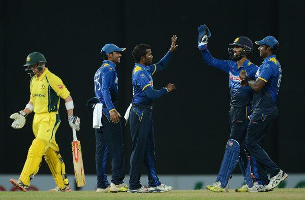 Sri Lanka's Amila Aponso (3L) celebrates with teammates after he dismissed Australia's George Bailey(L) during the second one-day International (ODI) cricket match between Sri Lanka and Australia at the R Premadasa International Cricket Stadium in Colombo on August 24, 2016. / AFP / LAKRUWAN WANNIARACHCHI (Photo credit should read LAKRUWAN WANNIARACHCHI/AFP/Getty Images)