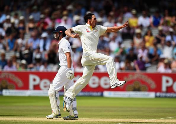 Mitchell Johnson of Australia celebrates after taking the wicket of Alastair Cook