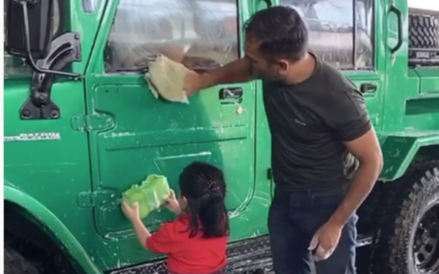 MS Dhoni gets assistance from Ziva as he washes his Nissan Jonga SUV