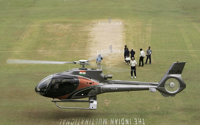 A helicopter tries to dry the pitch